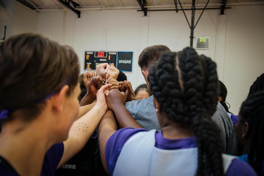 Athletes in huddle